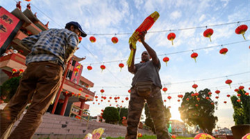 People hang lanterns for upcoming Spring Festival in Malaysia